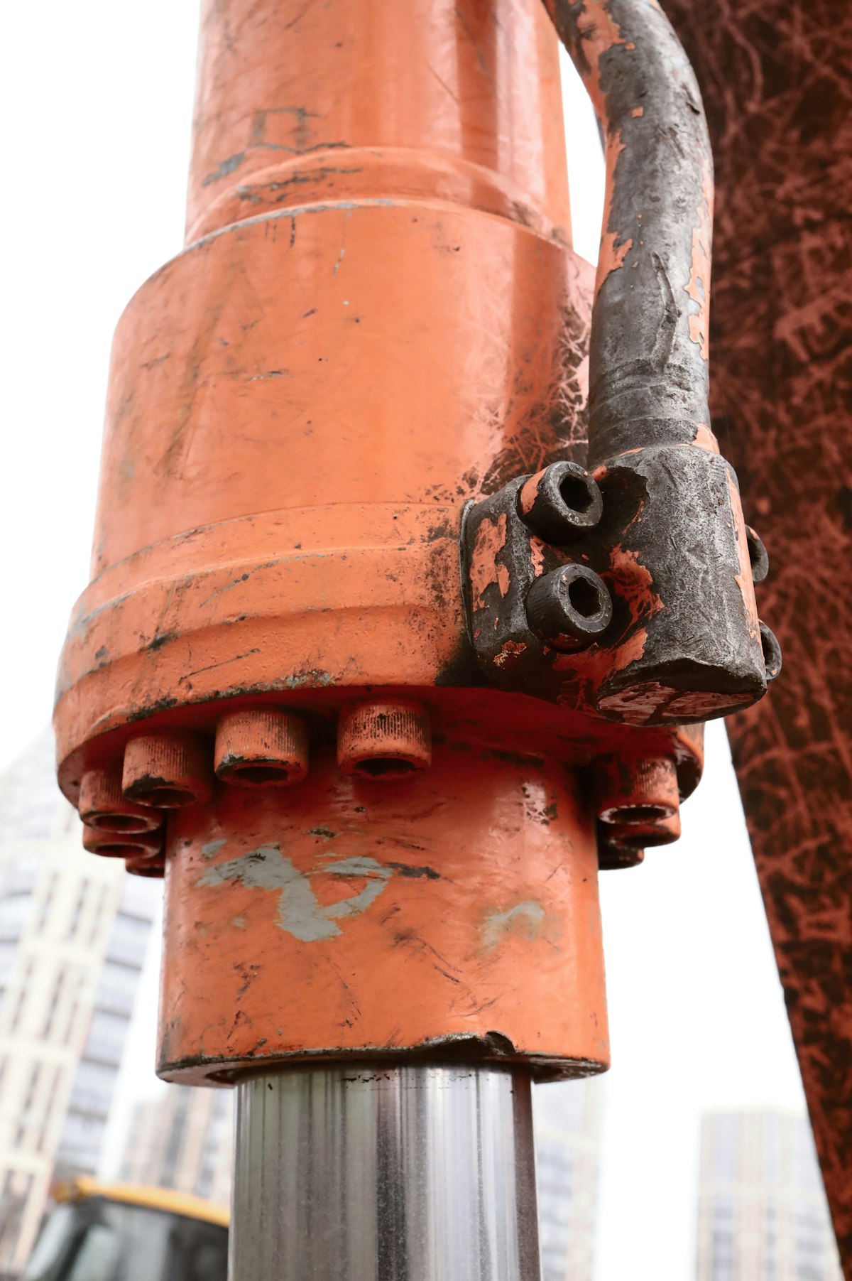 Close-up of an orange hydraulic cylinder